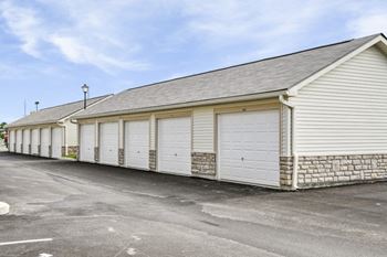 a row of white garages with white roller doors